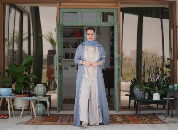 Omani artist Alia Al Farsi stands at door. Image by Burair Alkishri