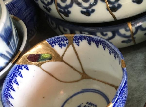 detail photo of a collection of pottery wares repaired via Kintsugi