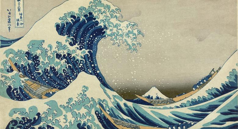 colored woodblock print of a giant wave crashing at sea with small boats beneath it