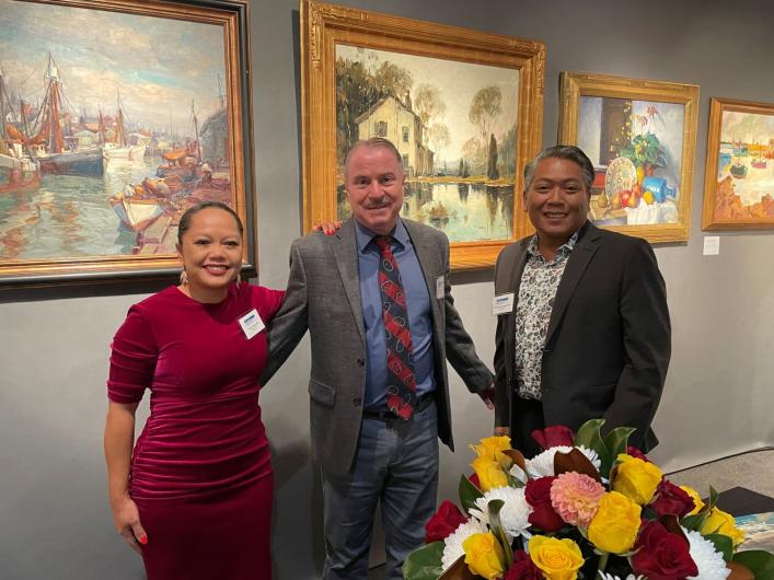 Gallery Owners pose in booth